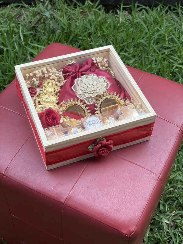 Wooden glass-lid box on a red stool