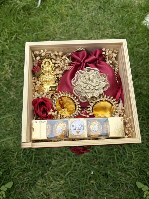 Box with red roses and Lakshmi idol